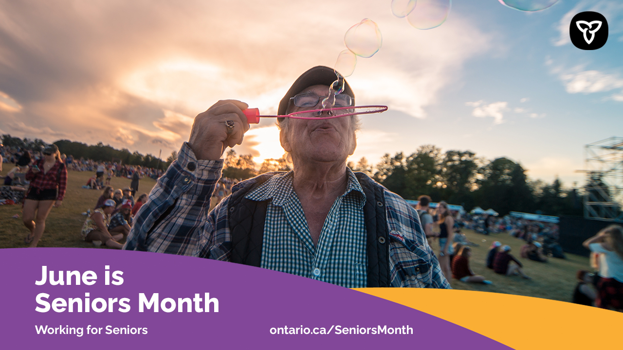 An older adult blowing bubbles outside. Text reads: June is Seniors Month. Working for Seniors. ontario.ca/SeniorsMonth.