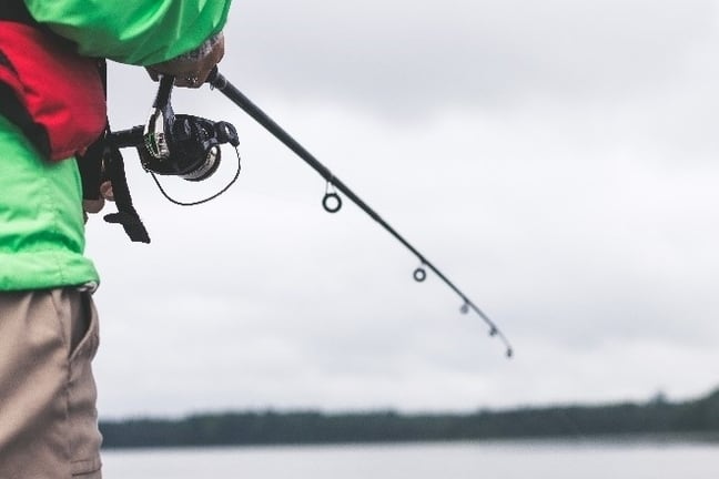 Image of person reeling in fishing rod. 
