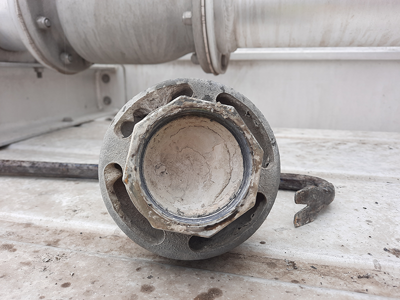 Pressure relief valve for tanker plugged with cement-like material