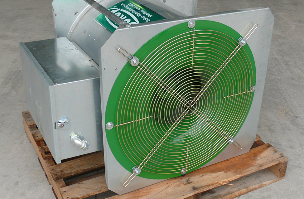 An in-line centrifugal fan sitting on a wooden skid. The air enters a circular screened opening at the end of the fan. The fan and electric motor are fastened.