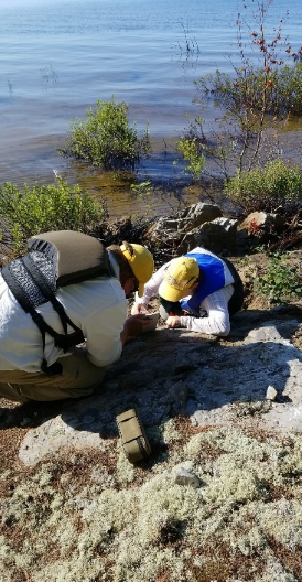 Evan Hastie and field assistant Jessica Verschoor examining an outcrop of sandstone from the Mississagi Formation.