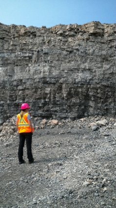 Summer student, Amy Cartier, looking at a section of a Quarry in Haldimand County