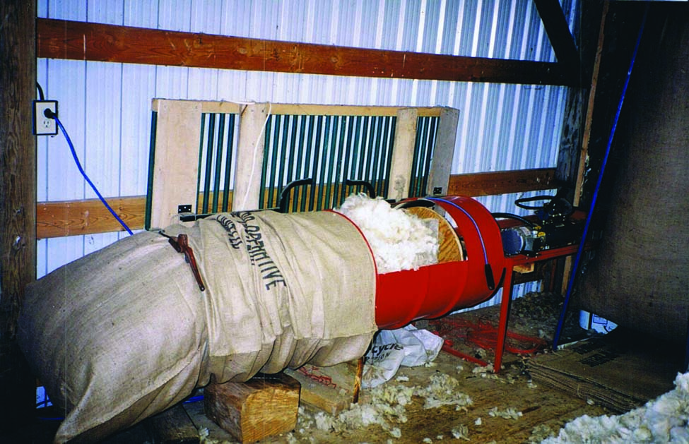 Photo of a wool bag on a hydraulically powered wool packer.