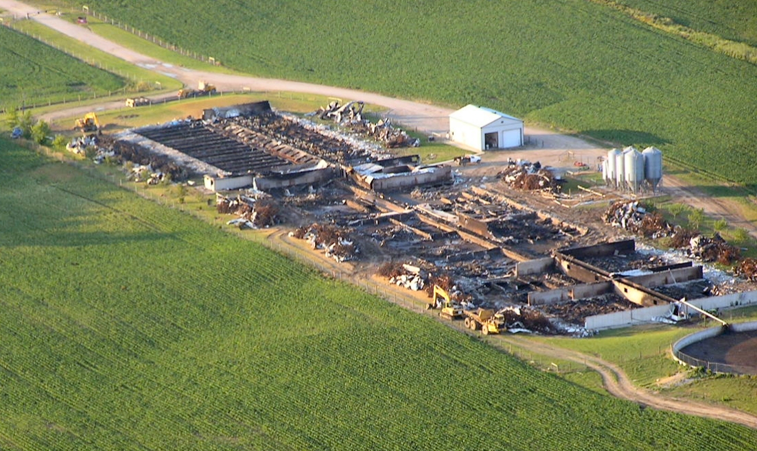 Aerial photo of a large swine operation that was completely destroyed by fire in less than one hour.  All that remains standing are feed bins and a drive shed in the background