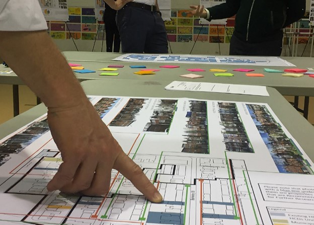A community member engages with a map of the Cabbagetown Southwest Heritage Conservation District study at a community and stakeholder consultation session