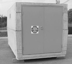 This is a photo of a prefabricated, square-shaped pesticide storage unit that is sitting slightly raised off the ground.