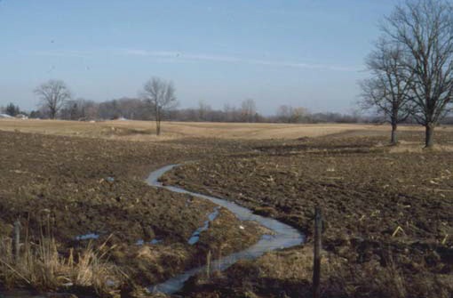 A private ditch or channel across a low area is not usually considered to be a natural watercourse.