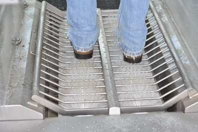 Figure 13. Photo of an automatic footbath consisting of mechanical brushes and sprayed disinfectant.