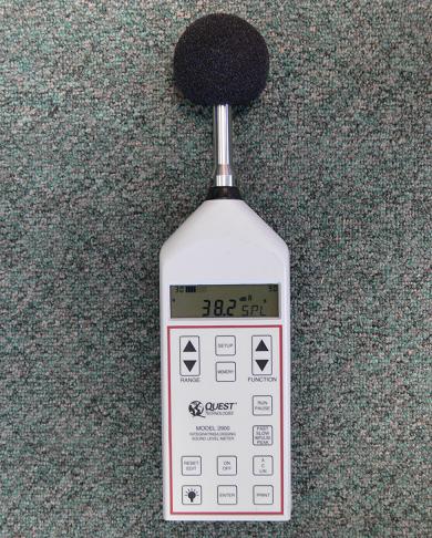 A close-up view of an integrating/logging sound meter displaying the sound level in the author's office of 38.2 dBA.