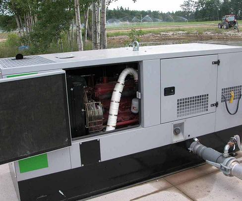 This picture shows a specifically designed insulated metal box housing around an irrigation pump to muffle the noise it produces. An engine access door is open.