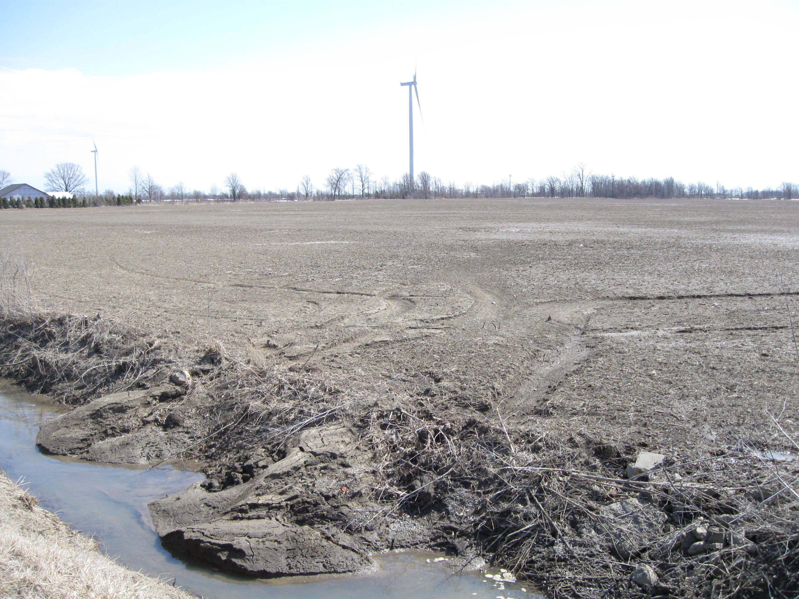 Sheet and rill erosion present on a tilled field with sediment deposition evident in the associated drainage ditch