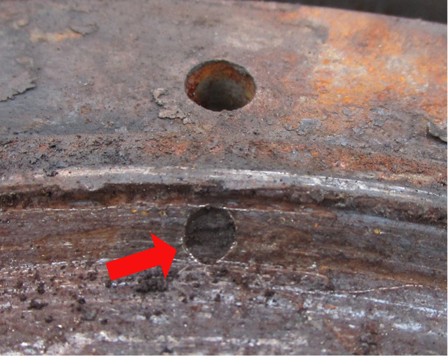 A close-up of the obstructed port that provides lubrication of the main shaft bearing