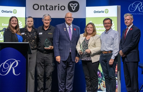 Minister Rob Flack and PA John Jordan awarding Farm & Food Care Ontario with the Excellence in Agriculture Minister Award.