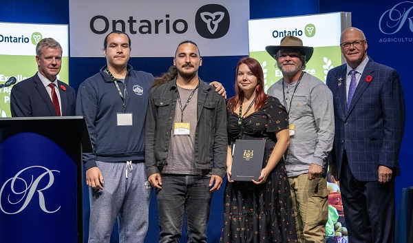 Minster Rob Flack and PA John Jordan awarding Wiijindamaan Indigenous Land Futurity and Gdoo-naaganinaa Garden, Conestoga College with the Urban Agriculture Excellence category Honourable Mention certificate.