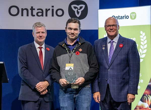 Minister Rob Flack and PA John Jordan awarding Aaron Bujold with the Northern Business  Excellence category award.