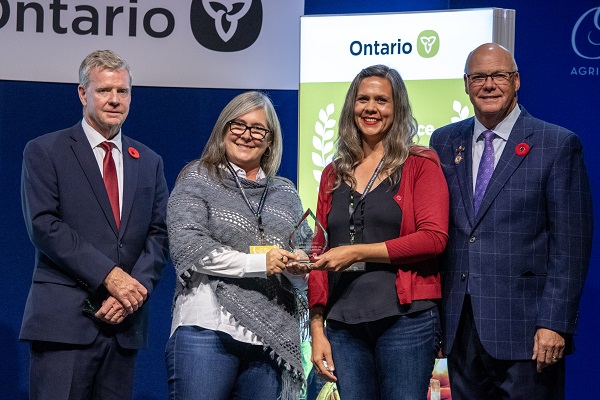 Minister Rob Flack and PA John Jordan awarding Jennifer and Melissa Schooley with the Farm Family Excellence category Award.