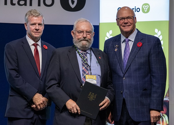 Minister Rob Flack and PA John Jordan awarding John Hemsted with the Farm Family Excellence category Honourable Mention certificate.