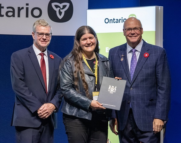 Minister Rob Flack and PA John Jordan awarding Dr. Amy Proulx with the Education Excellence category Honourable Mention certificate.