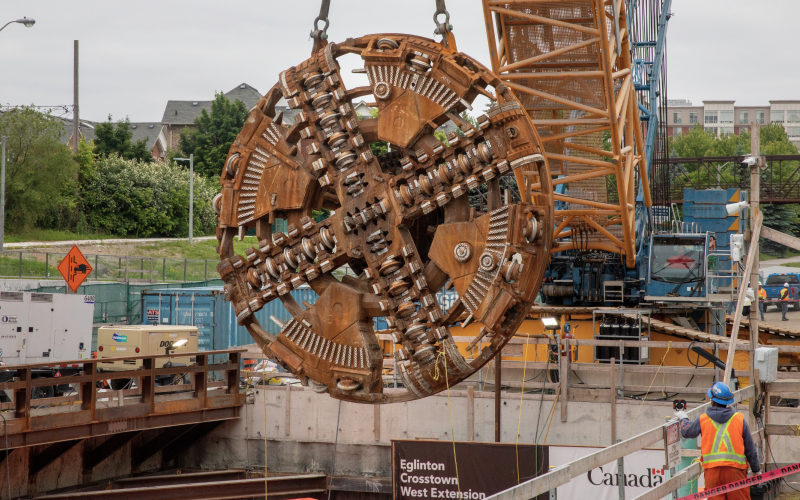 Eglinton Crosstown West Extension construction site showing placement of a cutter head for tunnelling.