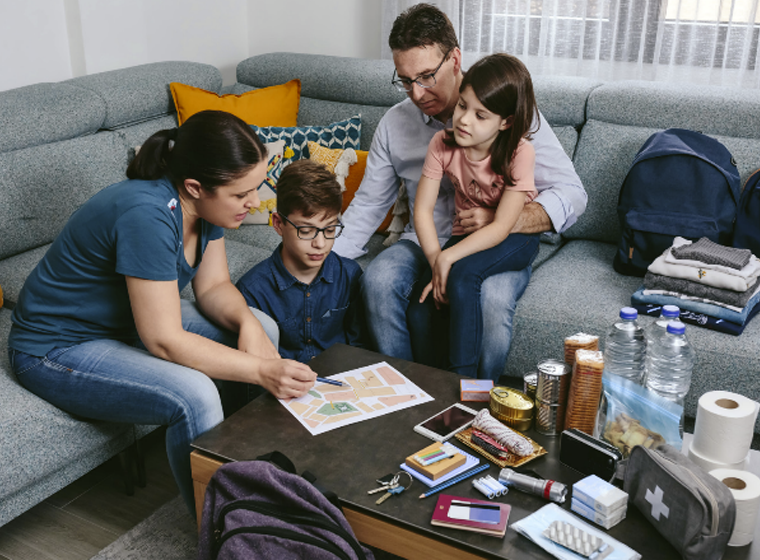 A family going over their emergency plan and kit items