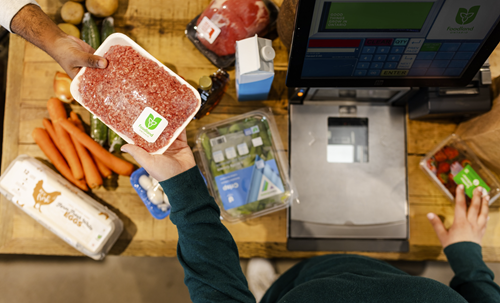 Photo of a grocery store checkout scanner with food products.