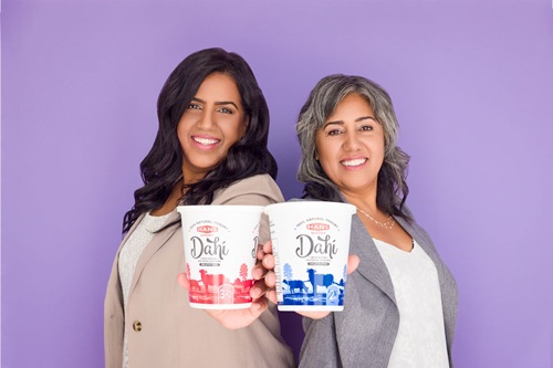 Photo of two Hans Dairy leaders holding products.