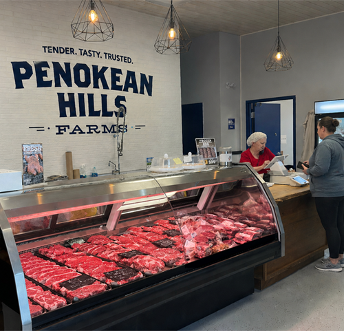 Photo of a meat counter at a Penokean Hills Farm shop.