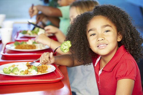 Photo of a young student eating lunch.